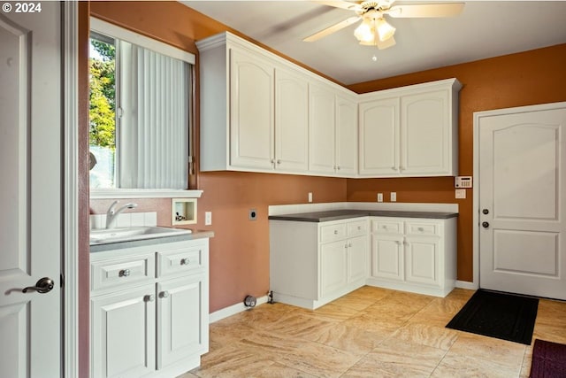 clothes washing area with ceiling fan, sink, cabinets, electric dryer hookup, and hookup for a washing machine