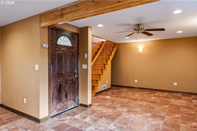 foyer entrance with ceiling fan