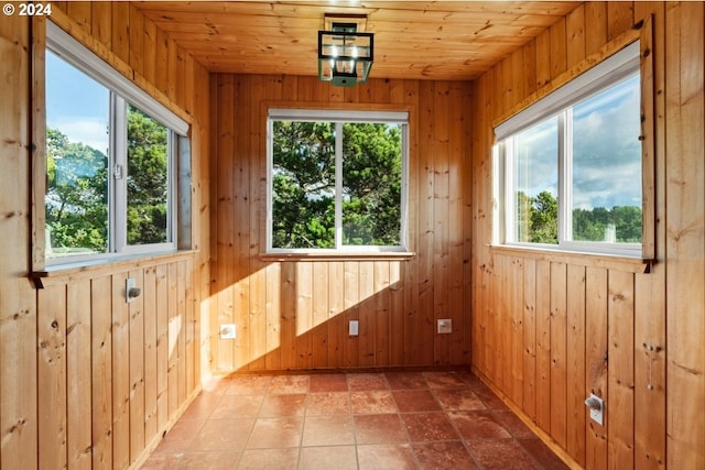 unfurnished sunroom with wood ceiling