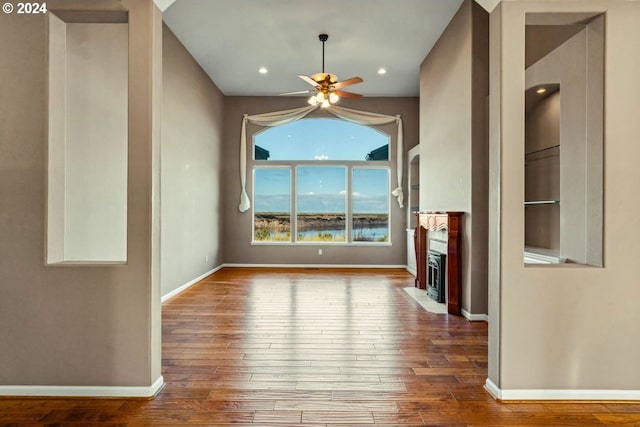 unfurnished living room with ceiling fan and hardwood / wood-style floors