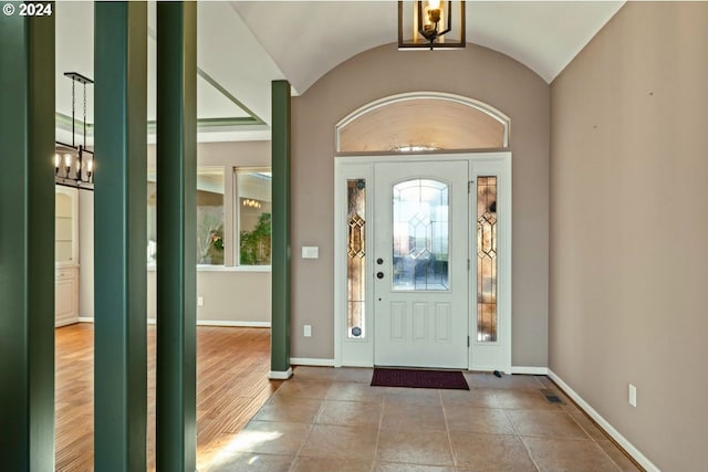 entrance foyer featuring hardwood / wood-style floors and lofted ceiling