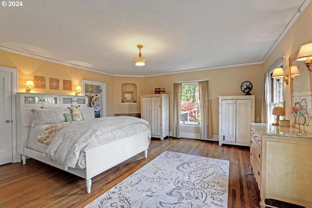 bedroom featuring dark hardwood / wood-style flooring, ornamental molding, and a textured ceiling