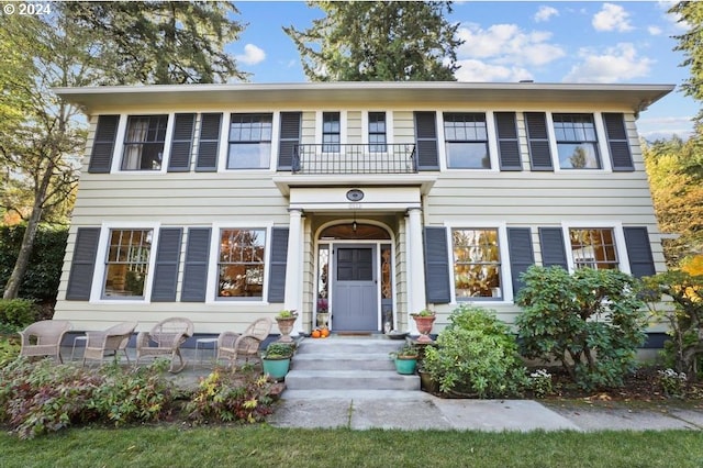 colonial-style house with a balcony