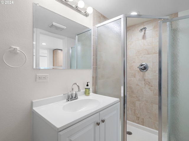 bathroom with vanity and walk in shower