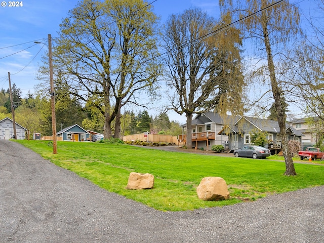 view of front of house with a front yard and a deck