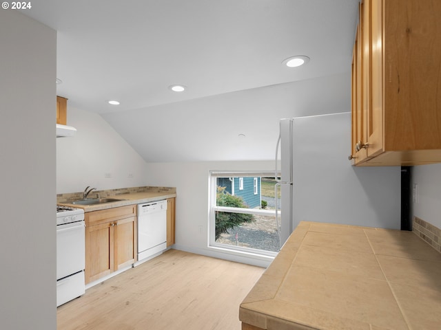 kitchen with white appliances, extractor fan, vaulted ceiling, sink, and light hardwood / wood-style flooring