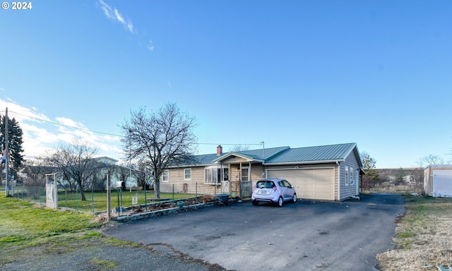 single story home featuring a garage and a front lawn