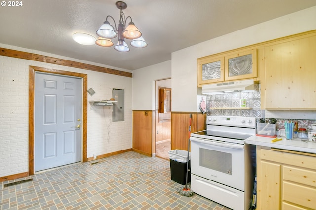 kitchen featuring white electric range oven, pendant lighting, a chandelier, electric panel, and wood walls