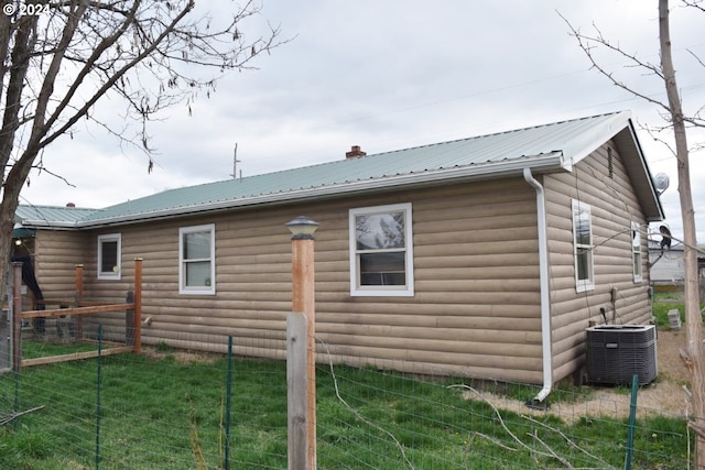 view of home's exterior featuring a yard and central AC