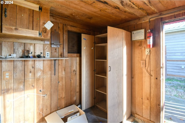 interior space with wood ceiling, wooden walls, and a healthy amount of sunlight