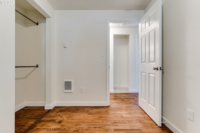 interior space with heating unit and light hardwood / wood-style flooring