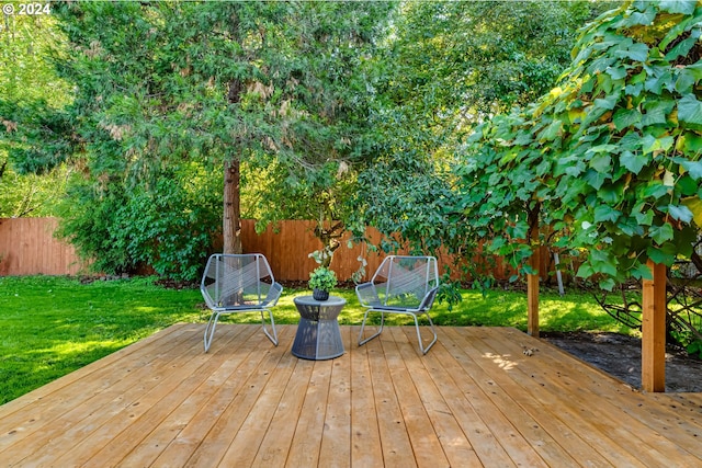 wooden deck with a lawn