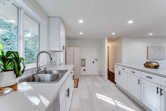 kitchen featuring white cabinets and sink