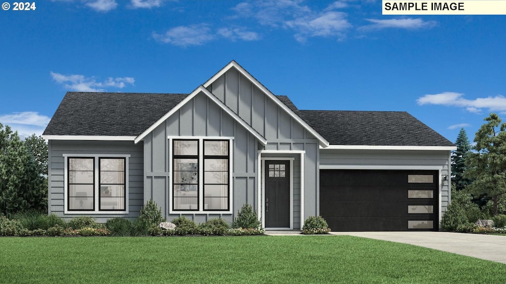 view of front of property with a garage and a front lawn