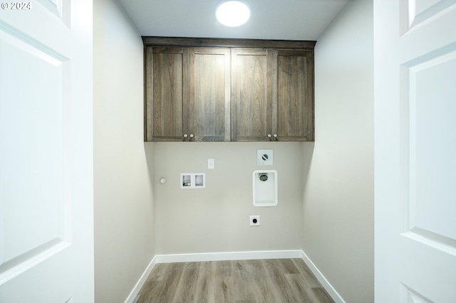 clothes washing area with light hardwood / wood-style flooring, cabinets, electric dryer hookup, hookup for a washing machine, and gas dryer hookup