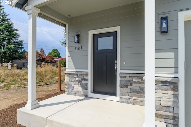 view of exterior entry with a porch