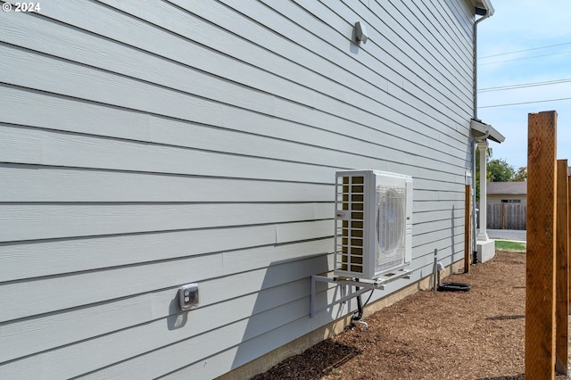 view of side of home with ac unit