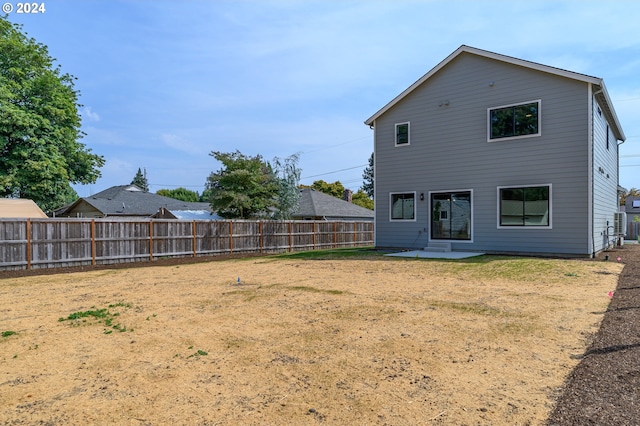 back of property featuring a yard