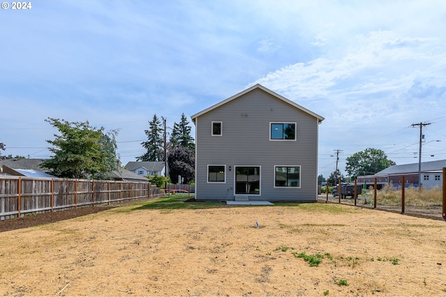 rear view of house featuring a lawn