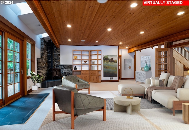 living room with carpet flooring, a wood stove, and wood ceiling