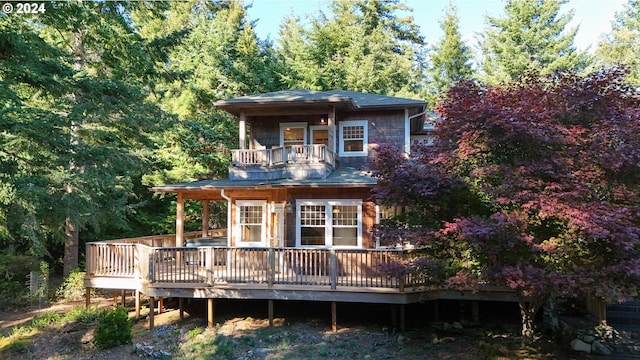 rear view of property with a balcony and a deck