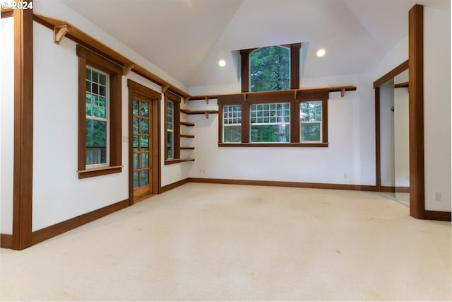 spare room with lofted ceiling and carpet floors