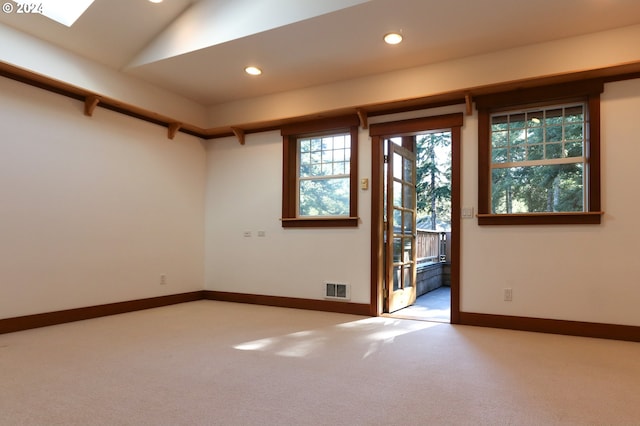 unfurnished room with carpet flooring and vaulted ceiling