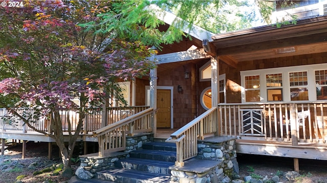 view of exterior entry featuring a wooden deck