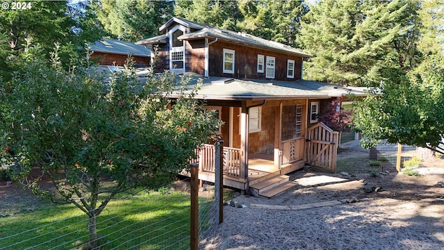 view of front of house with a deck and a front lawn