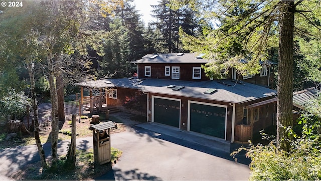 view of front facade featuring a garage and a wooden deck