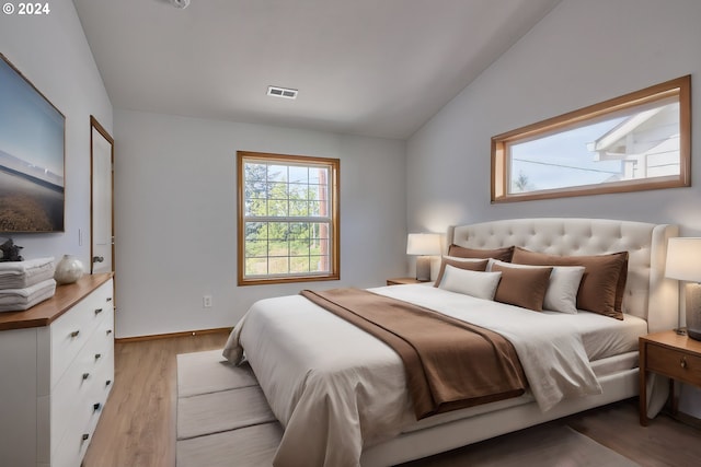 bedroom featuring vaulted ceiling and light hardwood / wood-style flooring