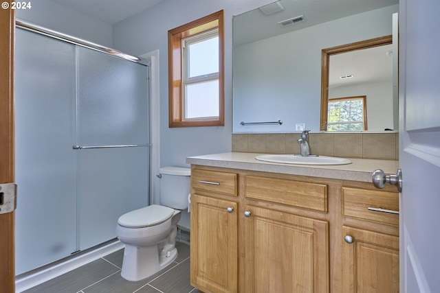 bathroom featuring an enclosed shower, tile patterned floors, toilet, and vanity