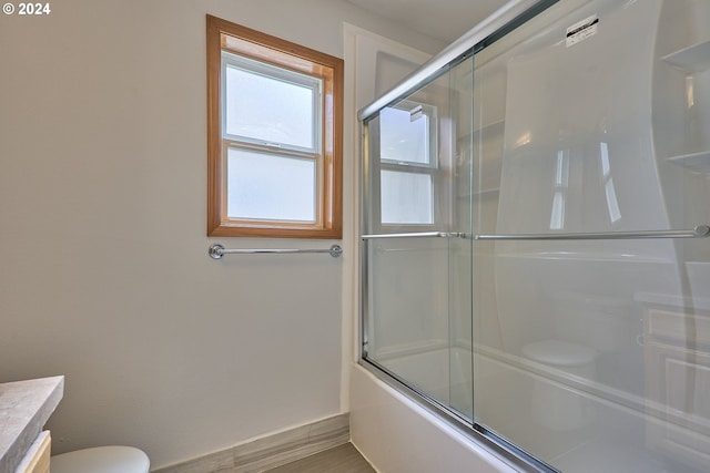 full bathroom featuring vanity, toilet, and enclosed tub / shower combo