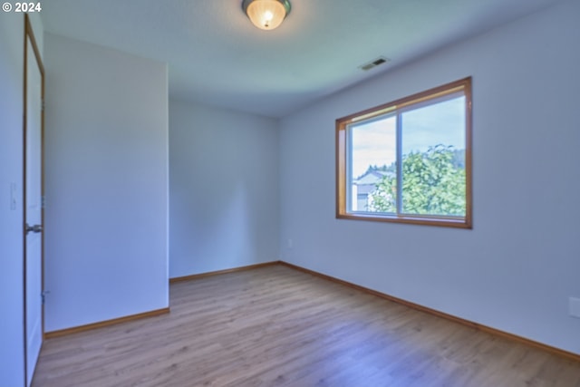 spare room with light hardwood / wood-style flooring