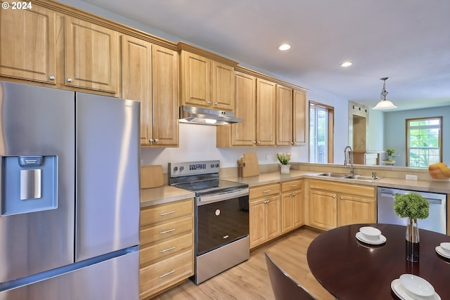 kitchen featuring decorative light fixtures, appliances with stainless steel finishes, light hardwood / wood-style floors, sink, and light brown cabinets