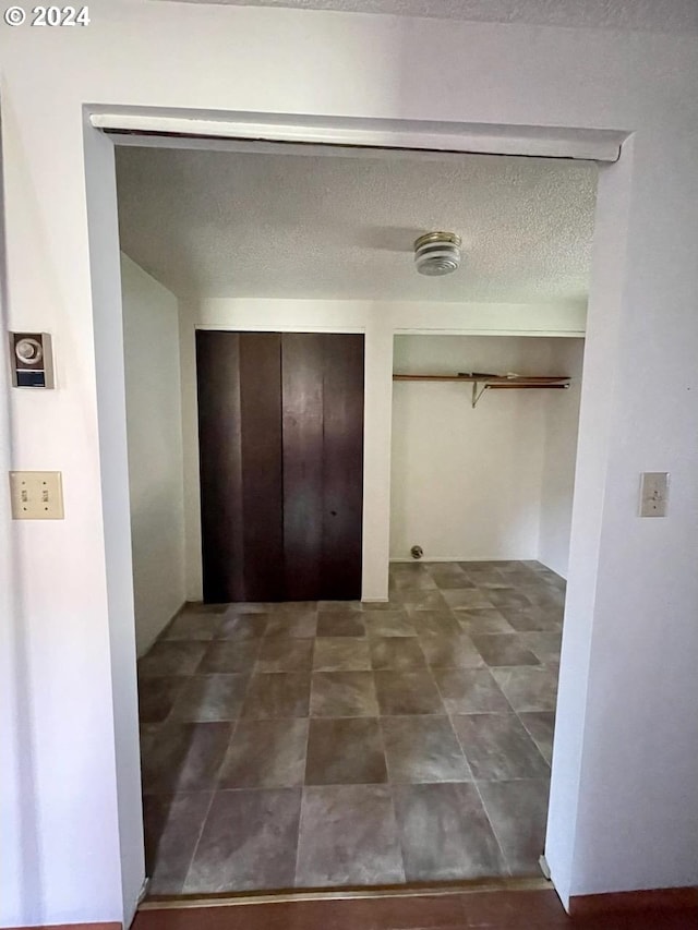 corridor with a textured ceiling