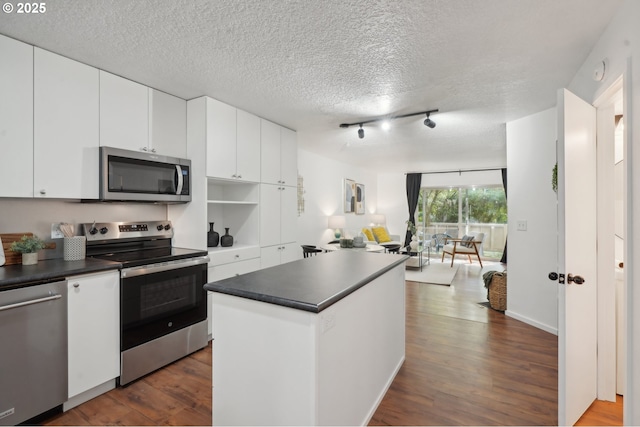 kitchen featuring white cabinets, dark hardwood / wood-style floors, and appliances with stainless steel finishes