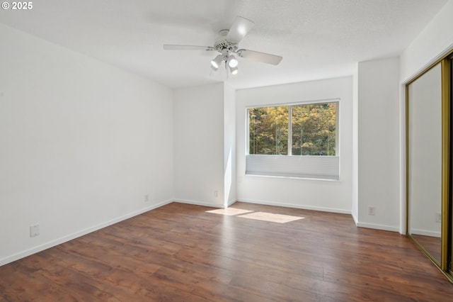 unfurnished bedroom with a closet, ceiling fan, and dark wood-type flooring