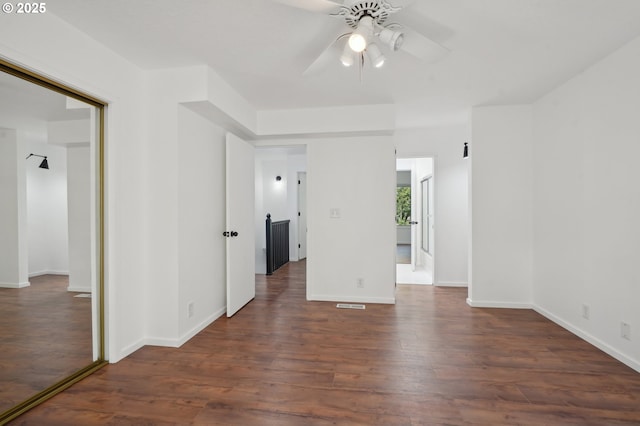 spare room featuring ceiling fan and dark hardwood / wood-style flooring