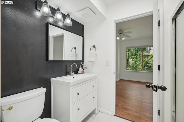 bathroom featuring tile patterned flooring, vanity, toilet, and ceiling fan