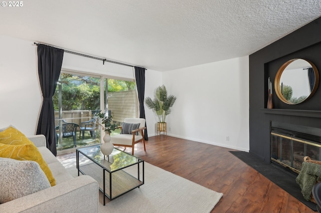 living room featuring dark hardwood / wood-style flooring and a textured ceiling