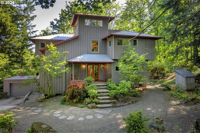 6733 NW Cornell Rd, Portland, OR 97229 - mid-century home with metal roof, an outdoor structure, driveway, a standing seam roof, and a detached garage