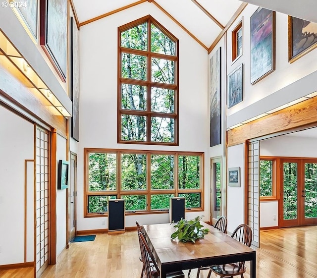 6733 NW Cornell Rd, Portland, OR 97229 - dining area featuring french doors, high vaulted ceiling, light wood finished floors, plenty of natural light, and baseboards