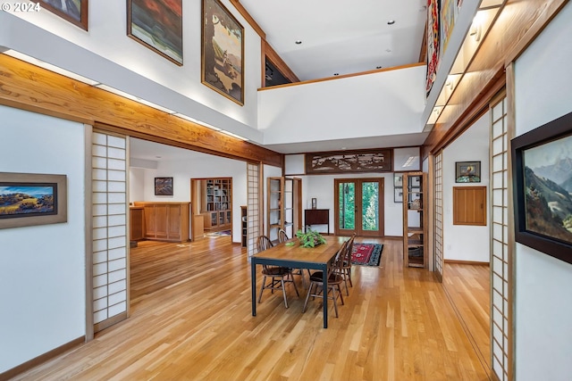 6733 NW Cornell Rd, Portland, OR 97229 - dining area featuring french doors, a towering ceiling, wood finished floors, and baseboards