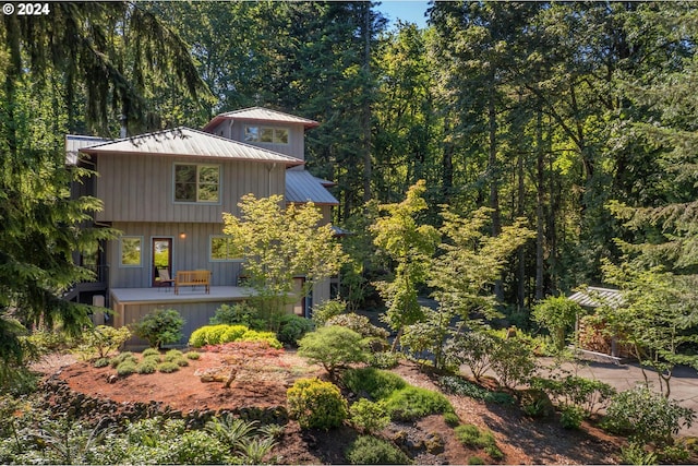 6733 NW Cornell Rd, Portland, OR 97229 - view of front of house with metal roof and a forest view
