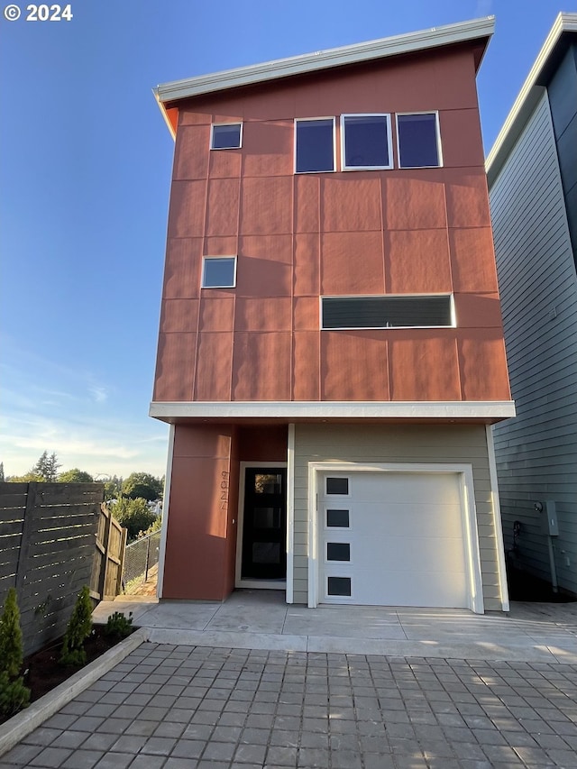 rear view of property featuring a garage