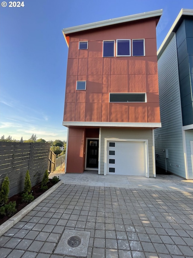 rear view of house with a garage