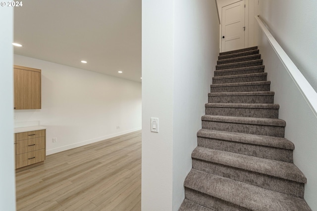 stairs with wood-type flooring