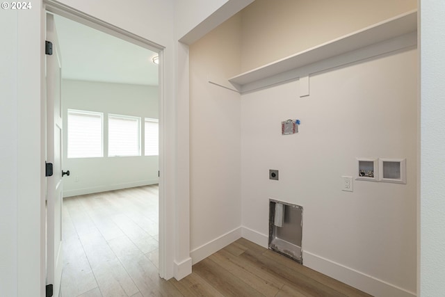 clothes washing area with electric dryer hookup, hookup for a washing machine, and light hardwood / wood-style flooring