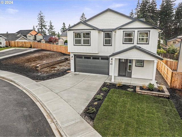 modern farmhouse featuring covered porch, a garage, and a front lawn